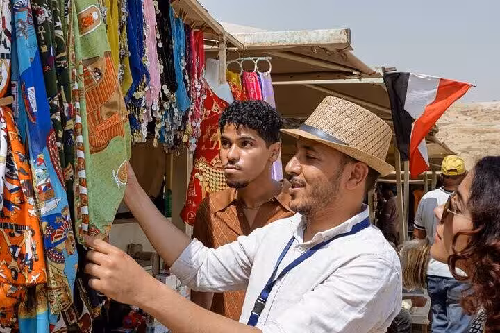 Tourists browsing colorful scarves at Khan El Khalili bazaar on a Cairo day tour shopping stop