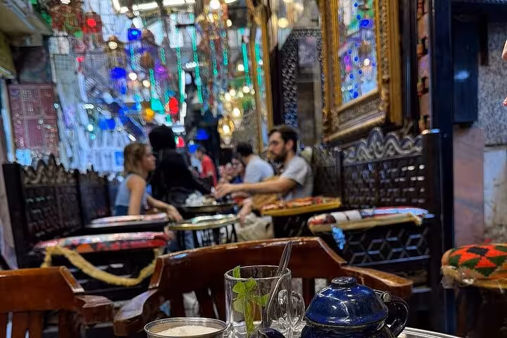 Traditional Cairo cafe in Khan el Khalili bazaar during market shopping tour, with mint tea and koshary