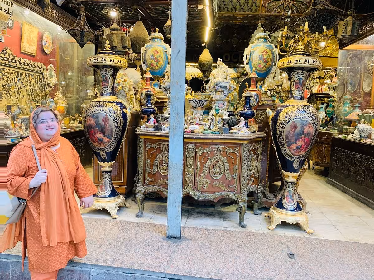 Traveler outside antique shop in Cairo Khan el Khalili Market, guided shopping experience with authentic Koshary lunch