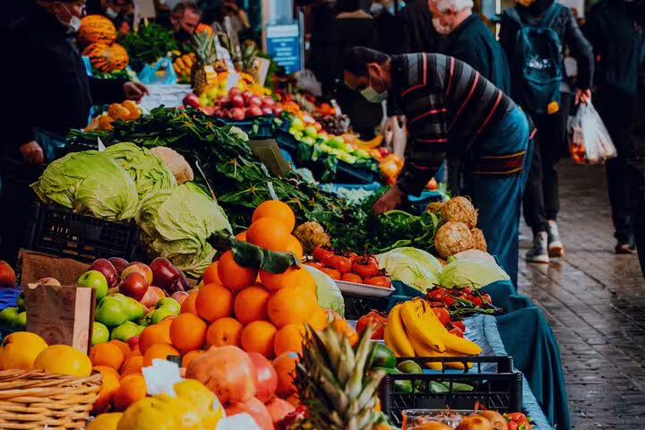 Colorful fruit and vegetable stalls at a Cairo local market tour, with shoppers browsing fresh produce and spices