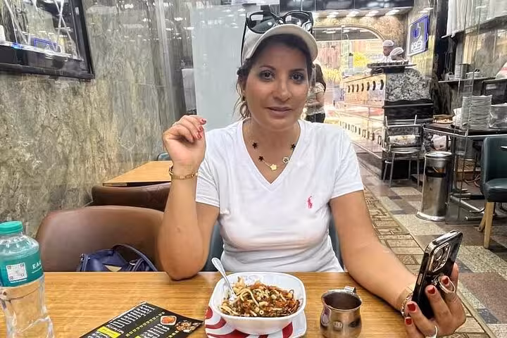 Traveler enjoying Egyptian lunch at a Cairo restaurant, included meal on camel ride, quad bike and shopping tour