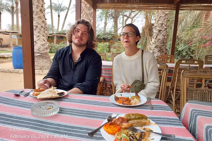 Guests enjoying Egyptian lunch in Cairo garden restaurant, perfect break on private Giza tour and bazaar day