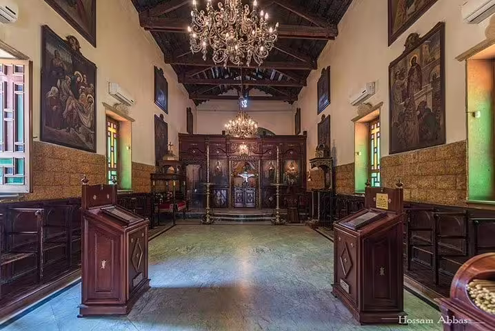 Historic Cairo church interior with chandeliers and carved wood iconostasis on luxury Four Seasons tour