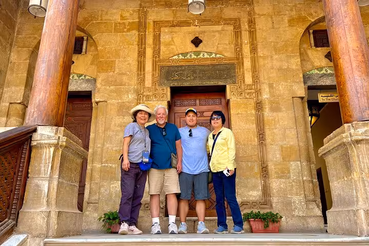 Tour group at historic Cairo mosque entrance on private 3-day Cairo Giza Alexandria city sightseeing and food tour