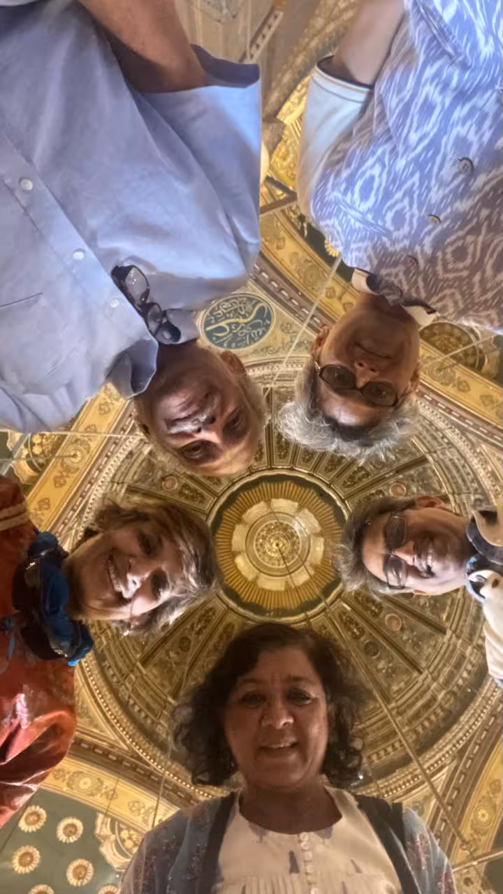 Group admires the intricate ceiling of a historic mosque in Cairo, part of the Egypt Golden 15 Days itinerary.