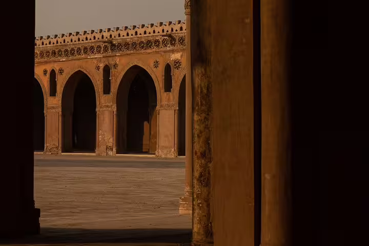 Sunlit arcades of the Mosque of Ibn Tulun courtyard in Cairo, a highlight of a 2-day short break tour