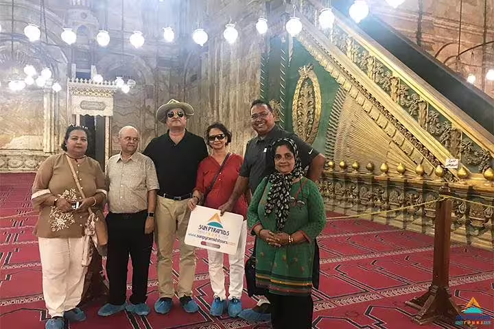Tour group inside Cairo mosque with ornate minbar, part of 8 days 7 nights Jewels of Egypt Luxor Aswan trip