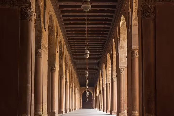 Long arched corridor with stone columns in a Cairo mosque, featured on Citadel, Bazaar and Cairo Mosques tour