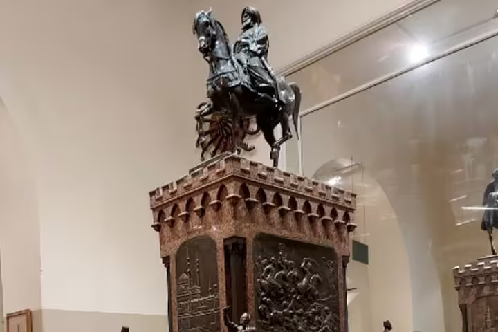 Equestrian statue atop ornate pedestal inside Cairo museum, featured on Cairo by Night tour near Al Moez Street