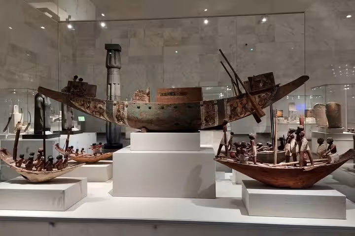 Ancient Egyptian funerary boat models on display inside Cairo National Museum of Egypt with QR ticket entry