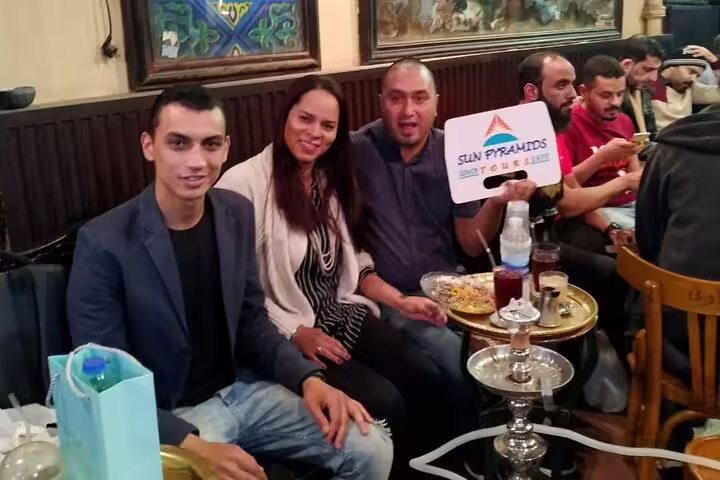 Tour guests relaxing with shisha and drinks at Al Fishawi café, part of Cairo by Night tour and Al Moez Street walk
