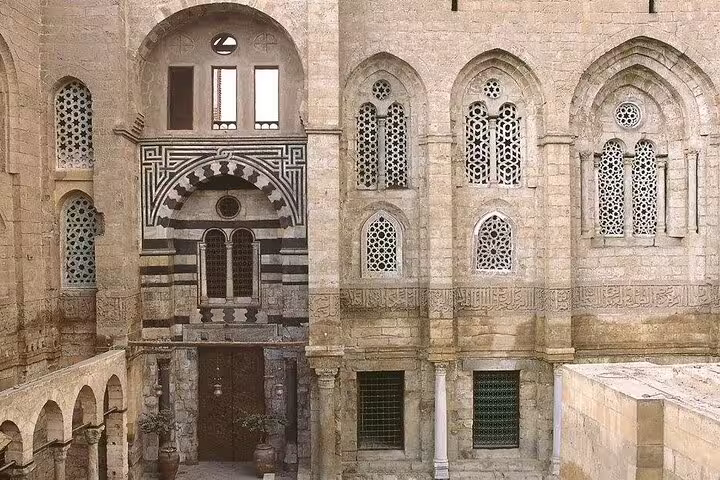 Historic Islamic Cairo stone facade with ornate windows, a stop on Cairo by night tour to El Fishawy Cafe
