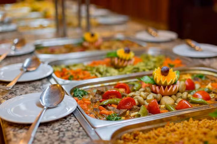 Egyptian buffet dinner on a Cairo Nile cruise, with hot trays of mezze, rice, and fresh salad for guests