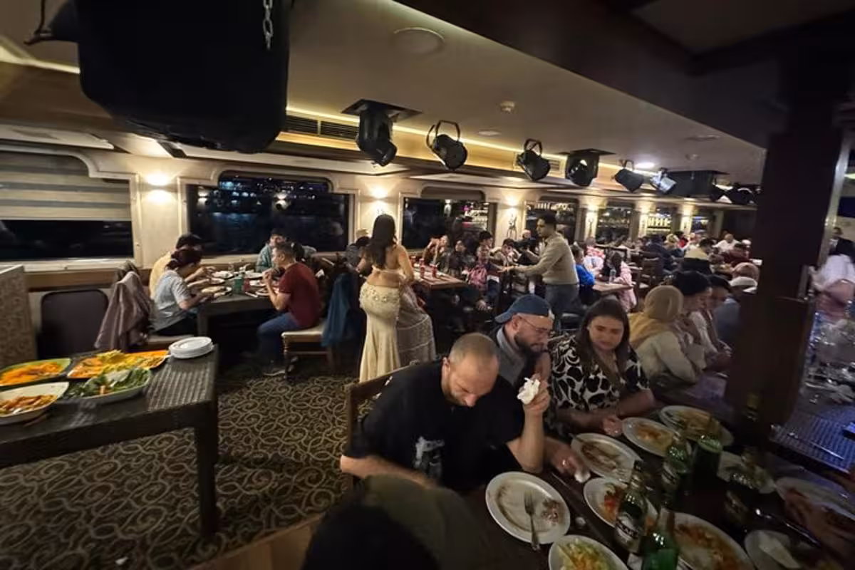 Guests dining on Cairo Nile dinner cruise with live belly dance show, dinner buffet and round-trip transfer
