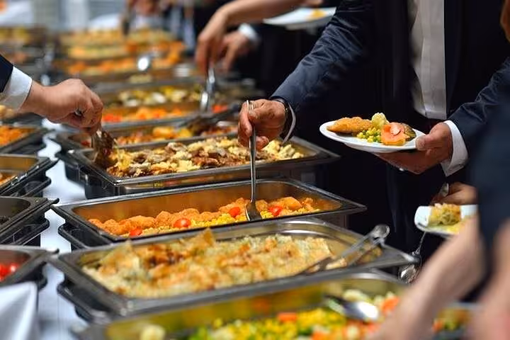 Buffet dinner on Cairo Nile cruise with Egyptian dishes being served, part of evening dinner and live show experience