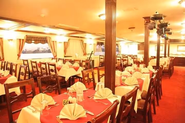Elegant Cairo Nile dinner cruise dining room with set tables, ready for buffet and belly dancing show