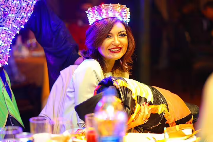 Guests enjoy Cairo Nile dinner cruise show with colorful lights, music and festive entertainment on board