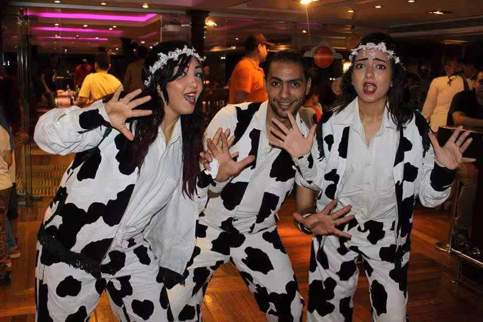 Costumed performers entertaining guests on a Cairo Nile River dinner cruise with live show and festive atmosphere