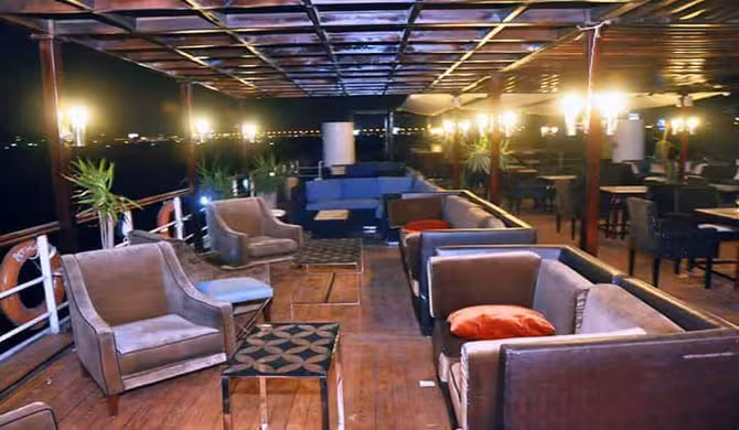 Open-air lounge deck on Cairo evening Nile dinner cruise with private transfer, seating and river views