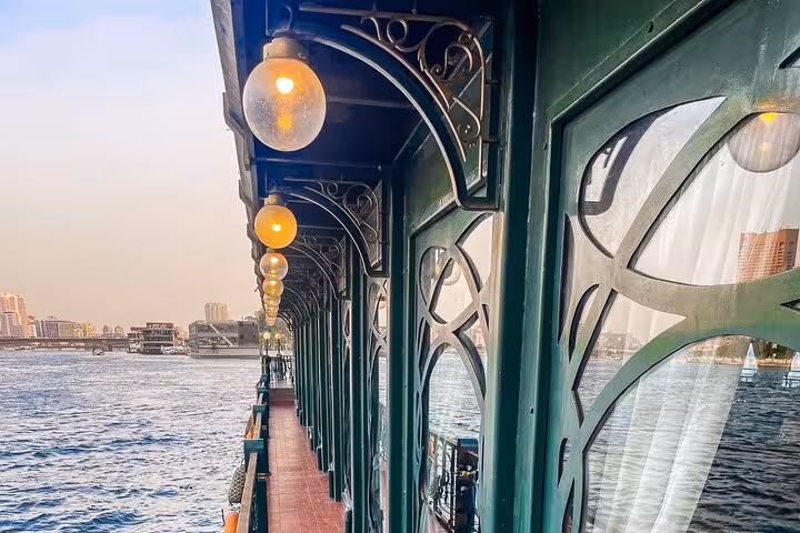Riverside deck walkway on Cairo Nile dinner cruise boat at sunset, heading to belly dancer and Tanoura show