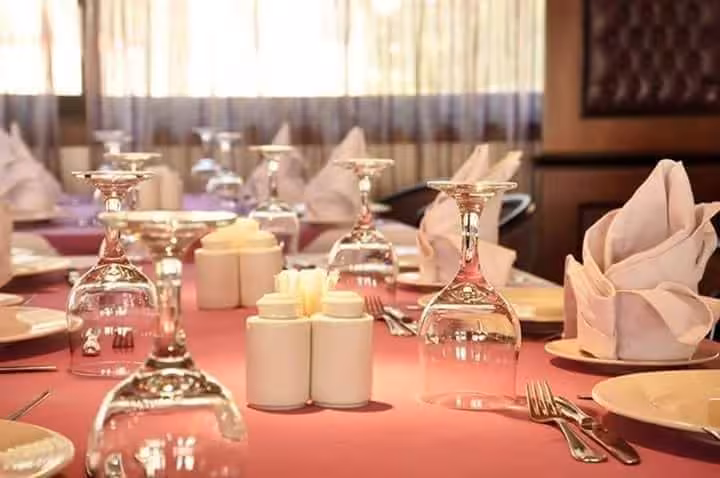 Table set for Cairo Nile dinner cruise with folded napkins and glassware, evening dining experience with private transfer