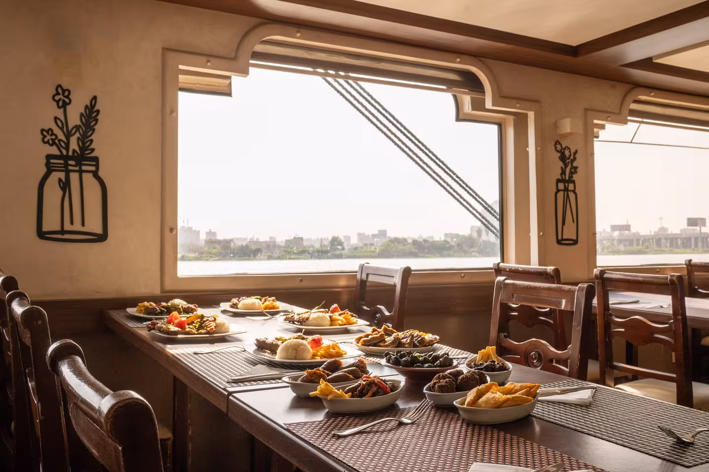 Nile River dinner cruise in Cairo with deluxe dining table set with Egyptian dishes and river views