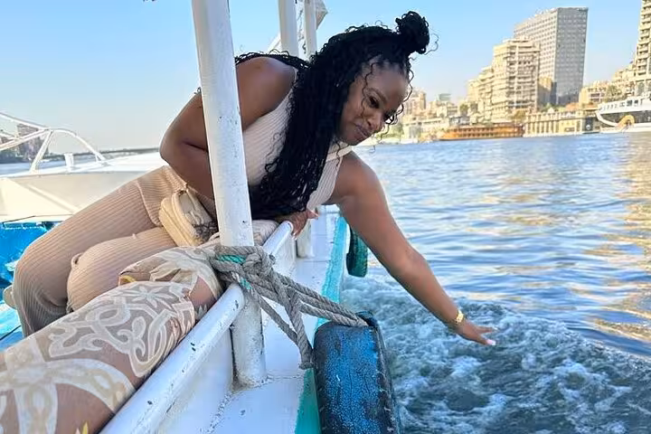 Traveler enjoying a Nile River felucca cruise in Cairo, part of a 4-day private tour itinerary