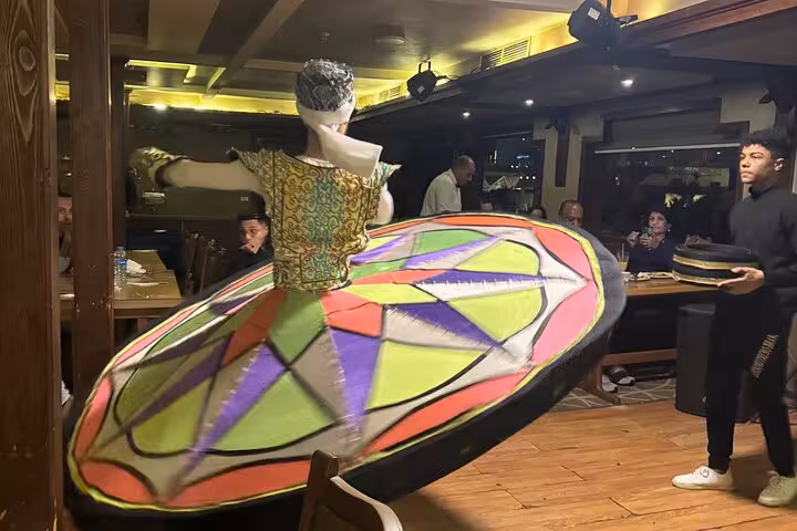 Tanoura whirling dancer show on Cairo Nile dinner cruise, colorful skirt spinning during onboard dinner