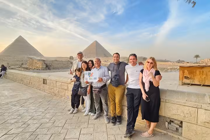 Family group at Giza Plateau with pyramids in background during Cairo private tour including Sphinx photo stop