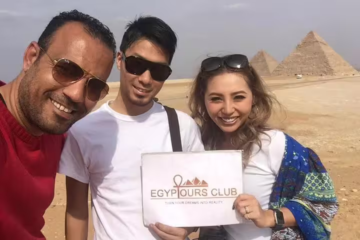 Travelers selfie at Giza Pyramids with guide, highlight of Cairo private tour package for 3 days