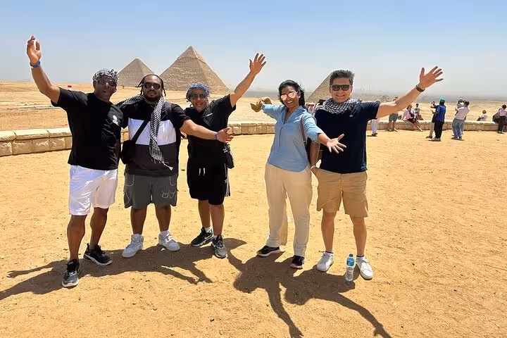 Group photo at the Pyramids of Giza during a 4-day private Cairo tour with guided sightseeing and transfers
