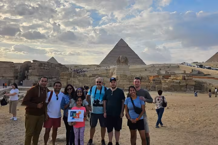 Group photo at Giza Pyramids and Sphinx viewpoint on fly to Cairo day tour with optional Tutankhamun mask