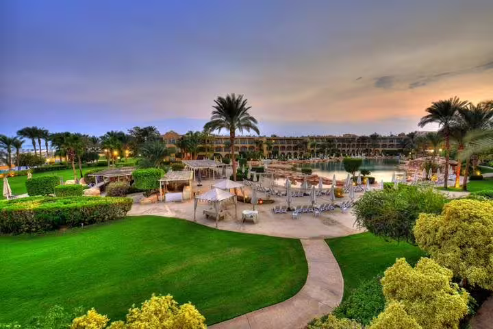 Sunset view over Red Sea resort gardens and lagoon pool, perfect escape on 4-day Cairo and Red Sea package