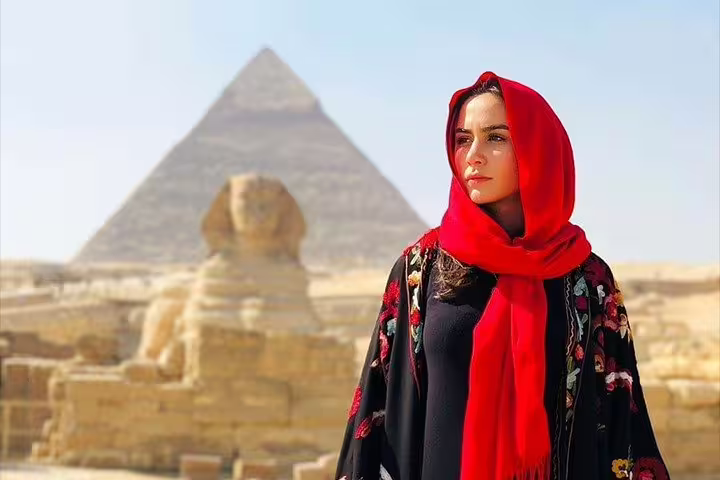 Woman in red scarf with Great Sphinx and Giza Pyramid, highlight of a 3-day Cairo short break package