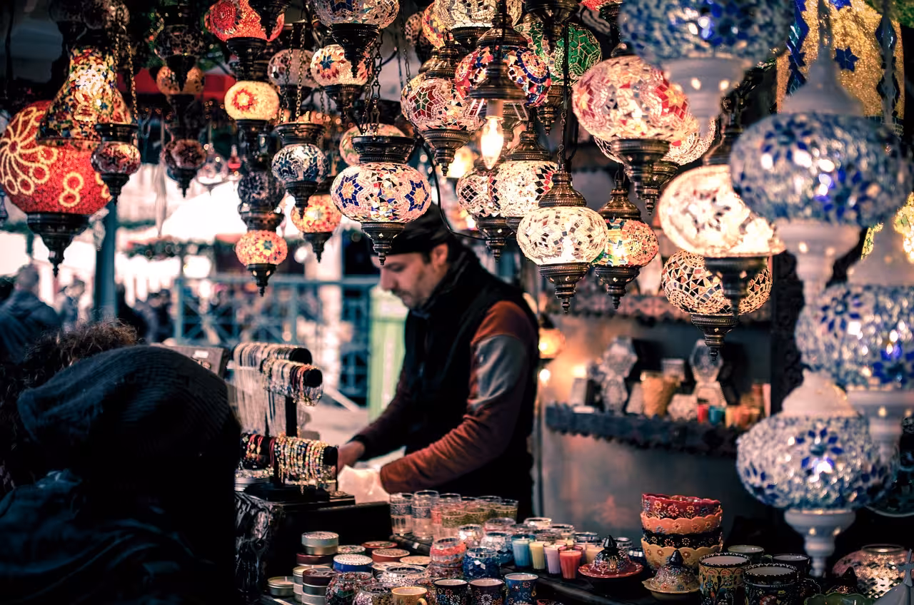 Vendor selling colorful mosaic Turkish lanterns and handcrafted souvenirs at a Cairo market stall