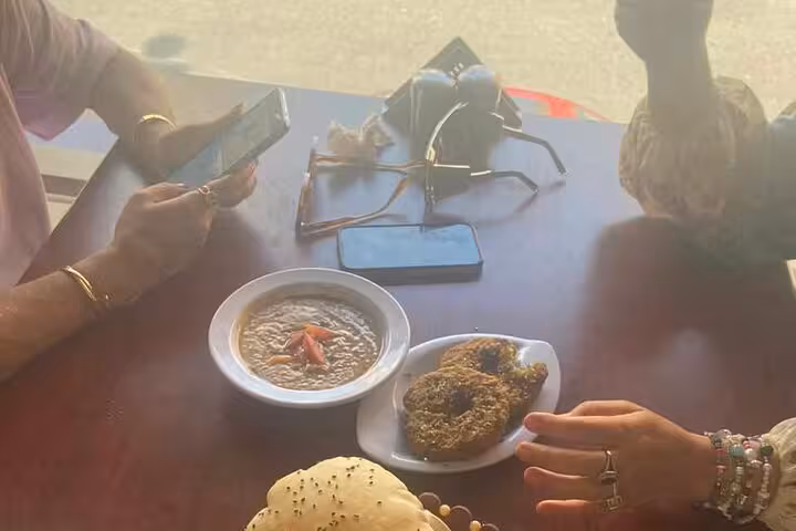 Koshary and falafel on table during a private Cairo street food tour, with guests sharing snacks on a walking tour