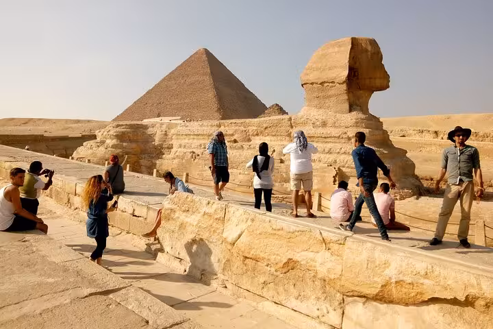 Tourists exploring the Great Sphinx and Giza Pyramid plateau, must-see experience on a 1 day Cairo tour package