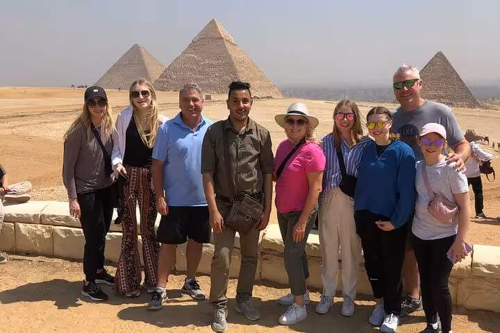 Tour group at Giza Plateau viewpoint with pyramids in background on a 3-day Cairo tour all inclusive