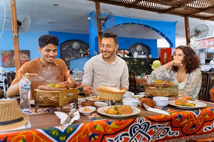 Travelers enjoying Egyptian lunch at a local Cairo restaurant during 2-day tour with bazaar and Citadel