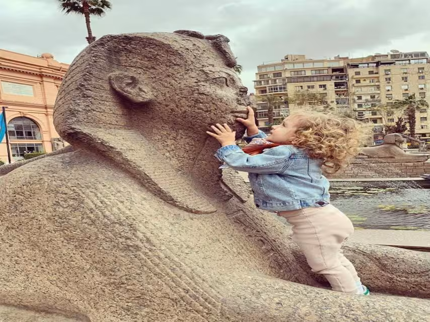 Traveler with sphinx statue outside the Egyptian Museum, family-friendly private Cairo tour and Old Cairo