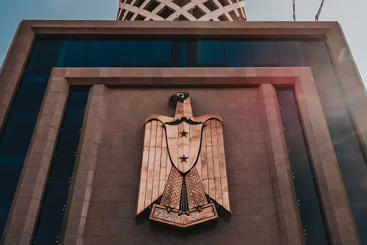 Eagle emblem on Cairo Tower entrance, part of El-Muizz Street tour with dinner and skyline views