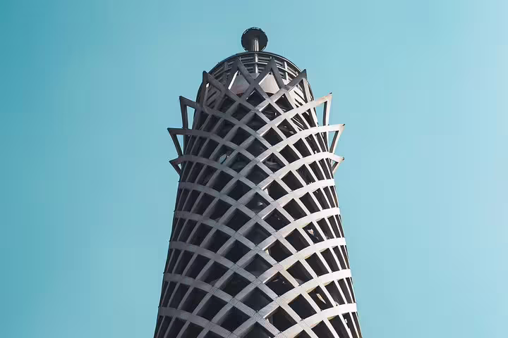 Close-up of Cairo Tower lattice design against blue sky, a highlight on El-Moez Street and Cairo city tour