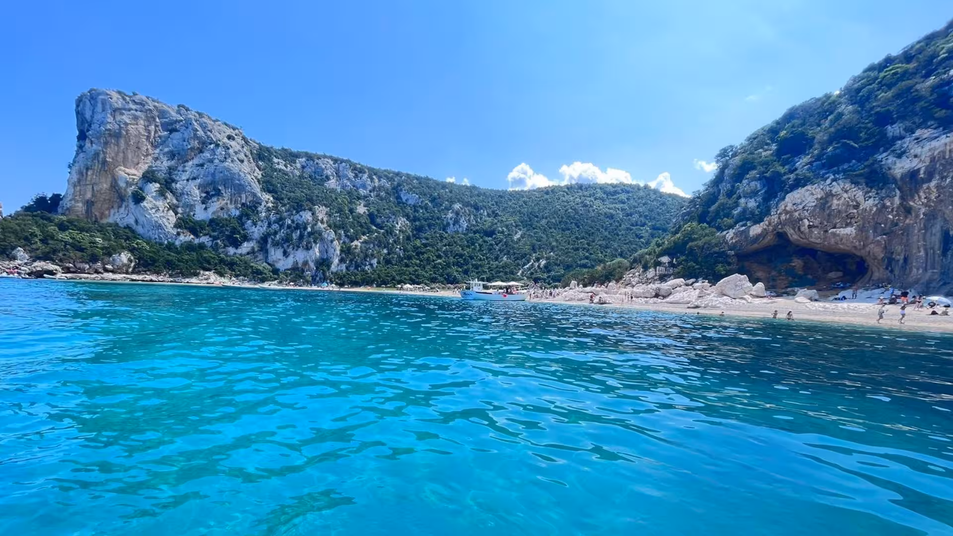 Breathtaking view of Cala Goloritzè's towering cliffs and crystal-clear sea in Sardinia, Italy.