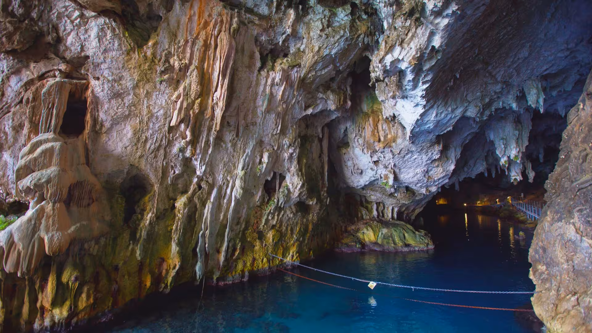 Discover the vibrant rock formations and azure waters at the entrance of Bue Marino Caves during the Cala Gonone motorboat tour.
