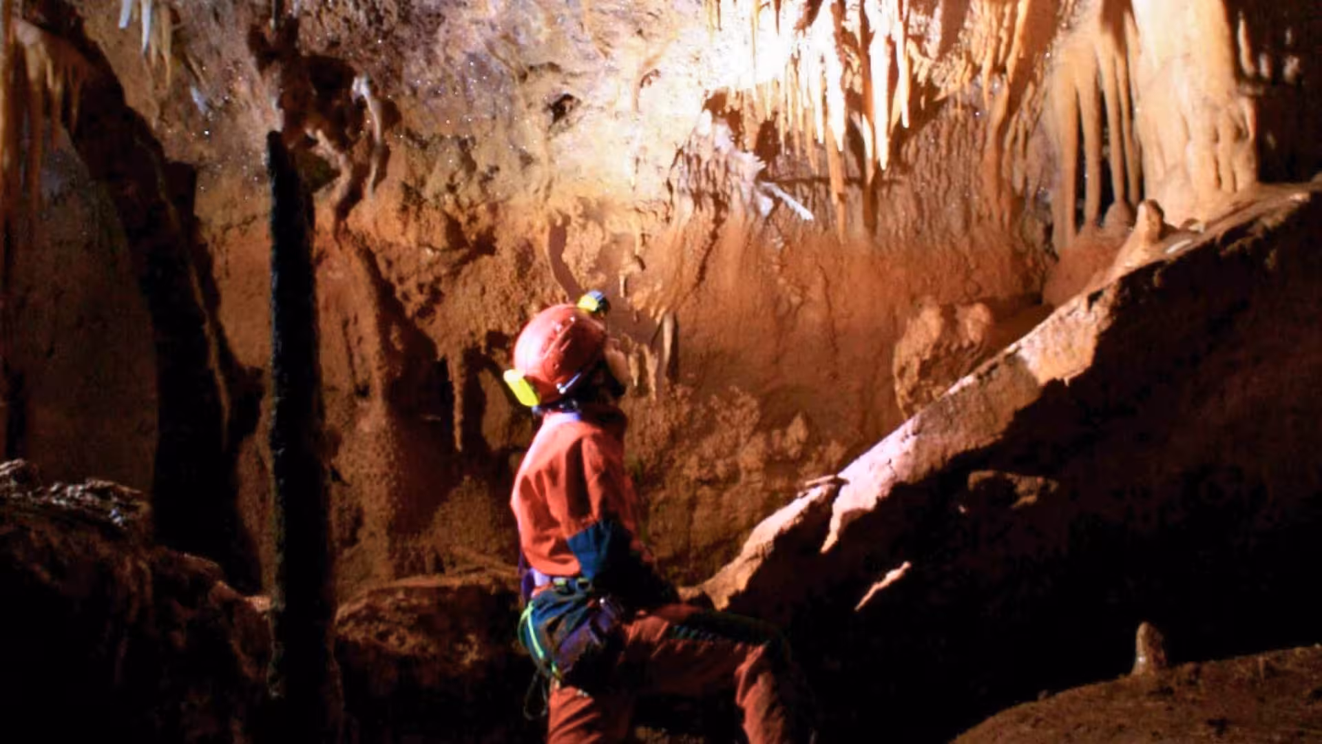Adventurer explores the stunning stalactites inside the Dorgali caves during a Cala Gonone caving excursion.