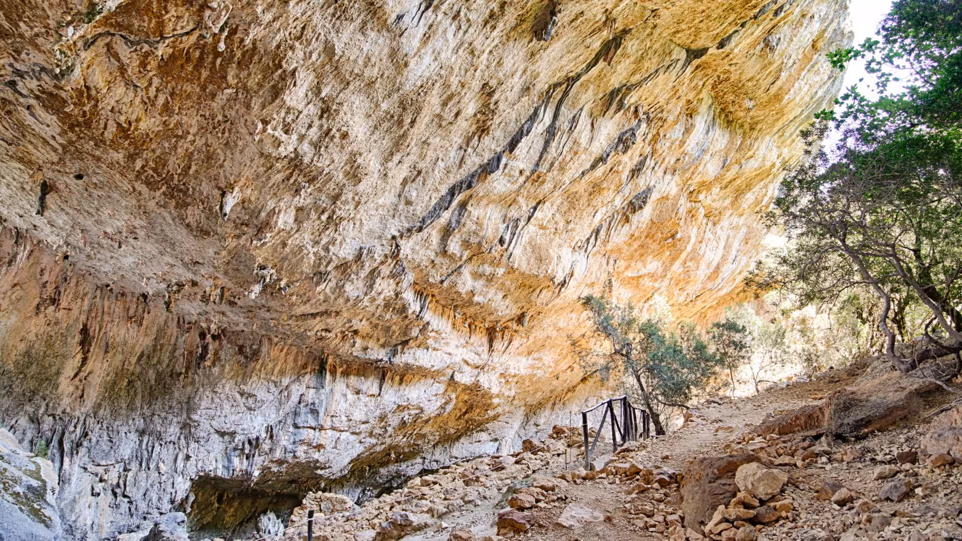 Rocky trail leading to the majestic Tiscali cave entrance, a must-see on the Cala Gonone trekking tour.