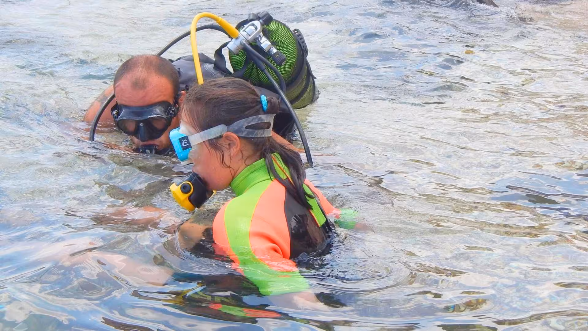 Instructor guides participant through Cala Gonone underwater baptism, showcasing immersive scuba diving for beginners.