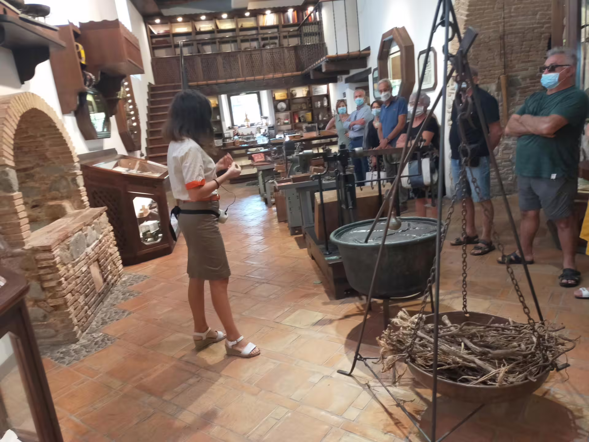 Guided group tour inside a traditional Calabrian museum near Cosenza, exploring rustic tools and local crafts on the itinerary