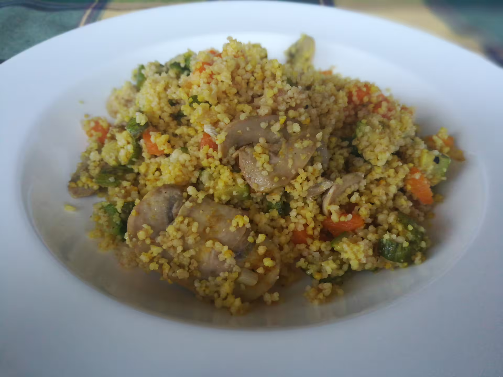 Colorful plate of Calabrian couscous with vegetables and mushrooms, showcasing traditional flavors on a Cosenza food tour