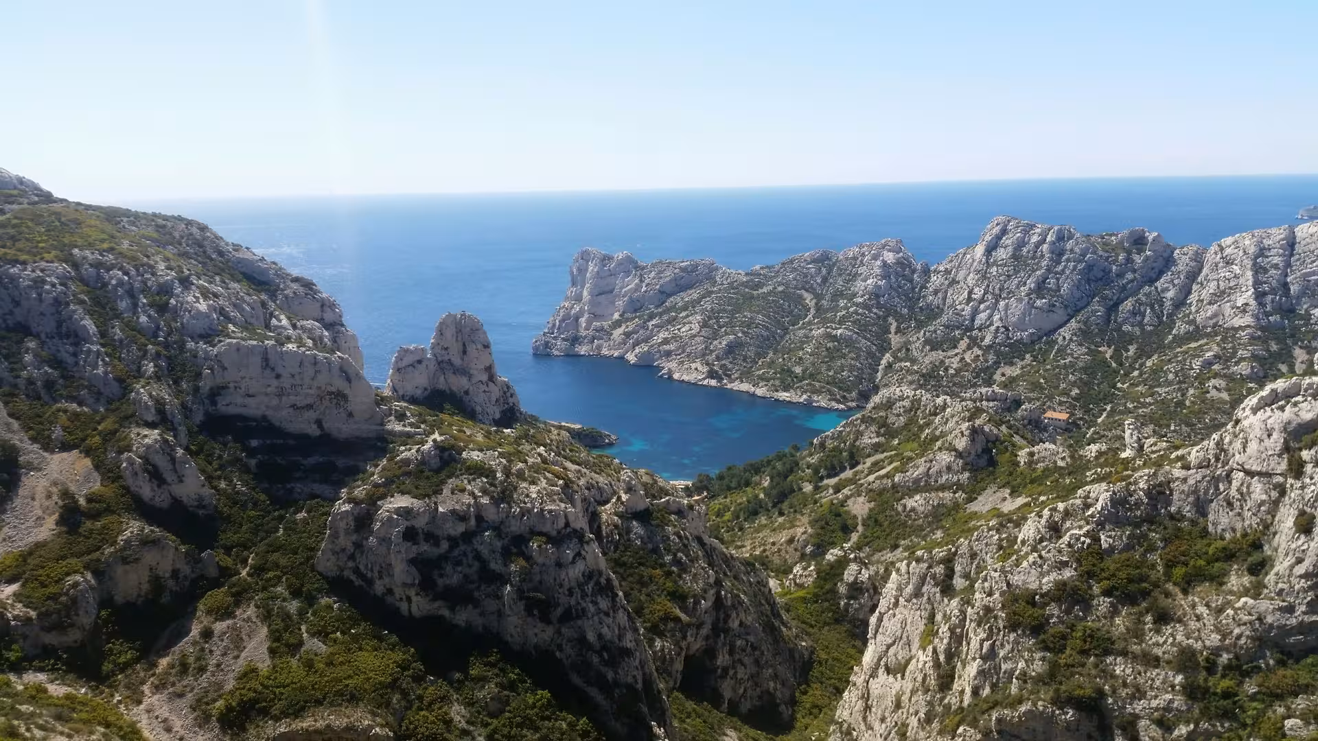 Panoramic hike view over a turquoise Calanque bay and limestone cliffs in Calanques National Park, Marseille